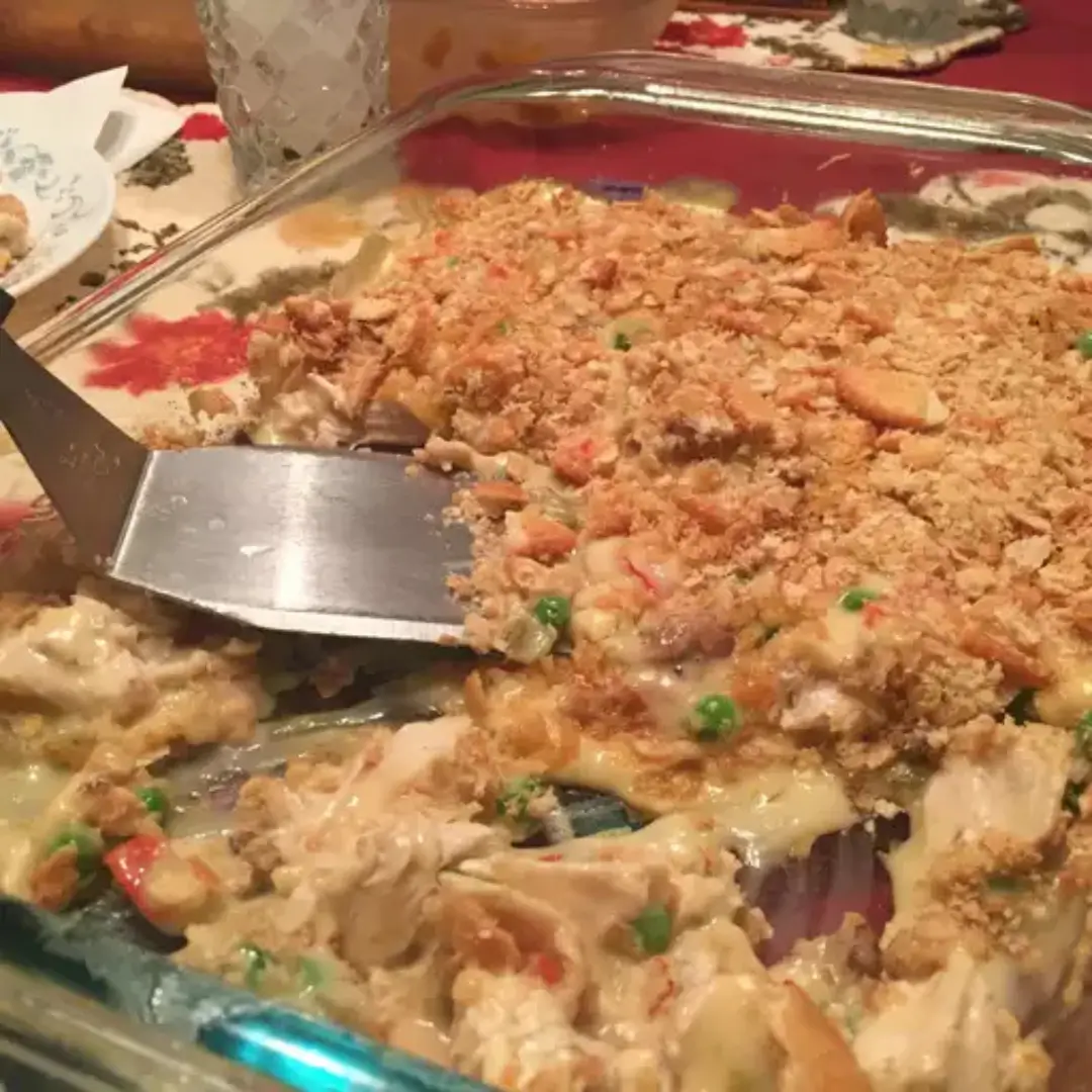 Creamy chicken casserole with golden cracker topping on marble surface